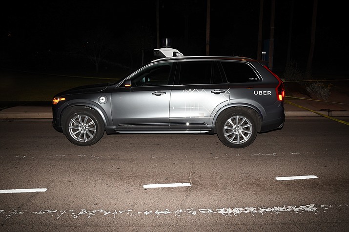 This file photo provided by the Tempe Police Department shows an Uber SUV after hitting a woman on March 18, 2018, in Tempe, Ariz. (Tempe Police Department via AP, File)