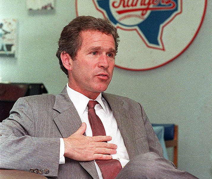 My good friend George W. Bush talks to reporters at Arlington Stadium in Texas on April 18, 1989.  (AP File Photo)