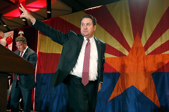 In this Nov. 4, 2014 file photo, Arizona Republican Attorney General Mark Brnovich waves to supporters at the Republican election night party in Phoenix. Brnovich beat January Contreras to remain Arizona's top attorney. (Ross D. Franklin/AP, file)