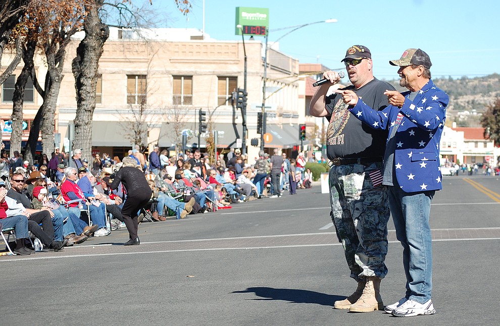 Lew Rees, right, with The Daily Courier's Courier Cares program, helps lead the crowd in the Marine Corps song at the start of the 2018 Veterans Day Parade in downtown Prescott on Saturday, Nov. 10. (Tim Wiederaenders/Courier)