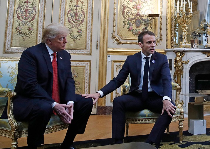 French President Emmanuel Macron touches the knee of President Donald Trump during their meeting inside the Elysee Palace in Paris Saturday Nov. 10, 2018. Trump is joining other world leaders at centennial commemorations in Paris this weekend to mark the end of World War I. (Jacquelyn Martin/AP photo)