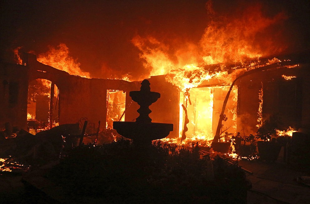 A Spanish-style home is consumed by flames on Dume Drive in the Point Dume area of Malibu, Calif., Friday, Nov. 9, 2018. Known as the Woolsey Fire, it has consumed tens of thousands of acres and destroyed multiple homes. (AP Photo/Reed Saxon)