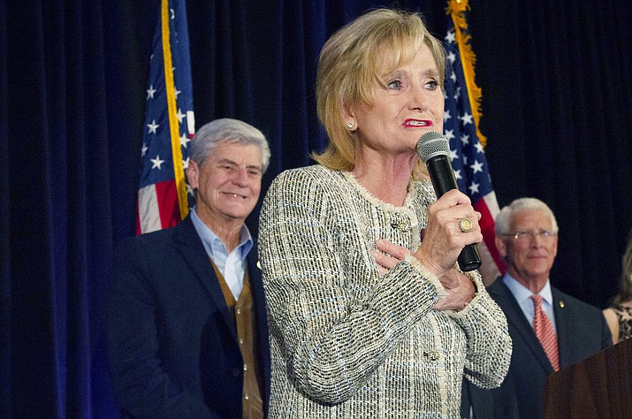 Sen. Cindy Hyde-Smith, R-Miss., speaks to supporters of her campaign during an election night party she shared with fellow Republican U.S. Sen. Roger Wicker, right, in Jackson, Miss., Tuesday, Nov. 6, 2018. Hyde-Smith, who was appointed to the seat, is in a Nov. 27 runoff against Mike Espy in this non-partisan race. The winner will serve the last two years of the six-year term vacated when Republican Thad Cochran retired for health reasons. (Sarah Warnock/The Clarion-Ledger via AP)