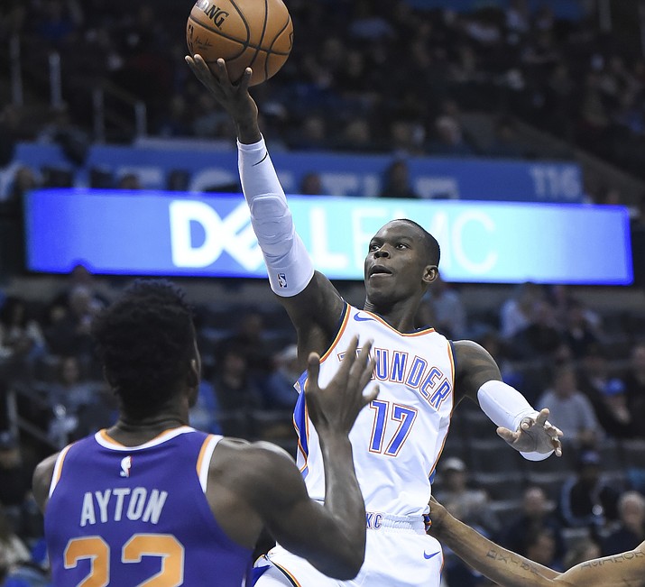 Oklahoma City Thunder guard Dennis Schroder (17) goes up for a shot over Phoenix Suns center Deandre Ayton (22) in the second half of an NBA basketball game in Oklahoma City, Monday, Nov. 12, 2018. (Kyle Phillips/AP)