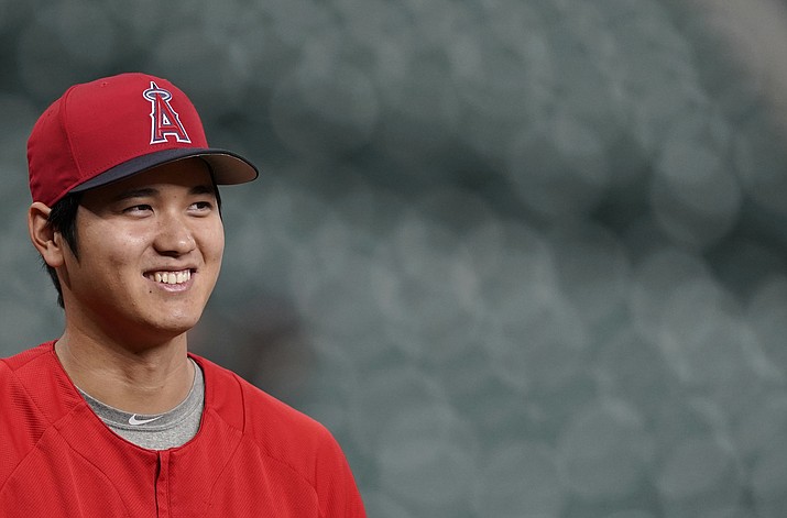 In this Sept. 21, 2018 photo Los Angeles Angels' Shohei Ohtani, of Japan, waits to stretch during batting practice before a baseball game against the Houston Astros in Houston. Ohtani has been voted American League Rookie of the Year after becoming the first player since Babe Ruth with 10 homers and four pitching wins in the same season. Ohtani, a 24-year-old right-hander who joined the Angels last winter after five seasons with Japan's Nippon Ham Fighters, received 25 first-place votes and four seconds for 137 points from the Baseball Writers' Association of America in balloting announced Monday, Nov. 12, 2018. (David J. Phillip/AP)