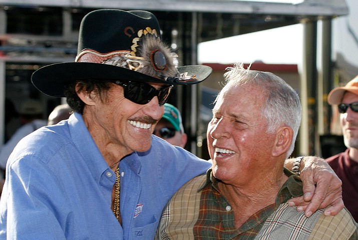 In this Friday, March 6, 2009 file photo, former NASCAR drivers Richard Petty, left, and David Pearson share a laugh during practice for the Kobalt 500 NASCAR Sprint CUp auto race at Atlanta Motor Speedway in Hampton, Ga. (AP Photo/Glenn Smith, File)