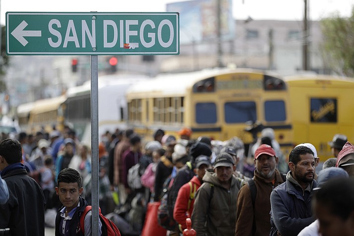 Central American migrants line up for a meal at a shelter in Tijuana, Mexico, Wednesday, Nov. 14, 2018. Migrants in a caravan of Central Americans scrambled to reach the U.S. border, catching rides on buses and trucks for hundreds of miles in the last leg of their journey Wednesday as the first sizable groups began arriving in the border city of Tijuana. (Gregory Bull/AP)