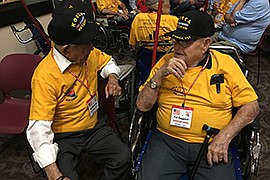 Pat Kinnerup, left, and Bill Haggard reminisce before boarding an Honor Flight in Phoenix. The two have been friends for seven decades. (Photo by Lillian Donahue/Cronkite News)