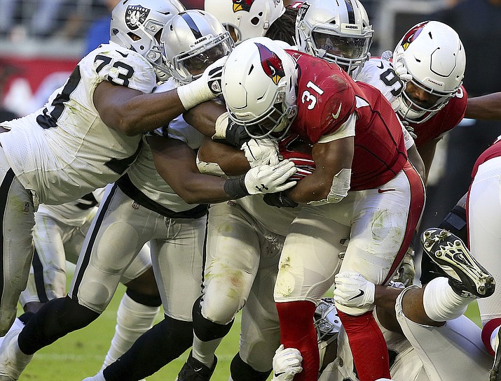 Arizona Cardinals running back David Johnson is stopped for no gain against the Oakland Raiders during the second half Sunday, Nov. 18, 2018, in Glendale. (Ross D. Franklin/AP)