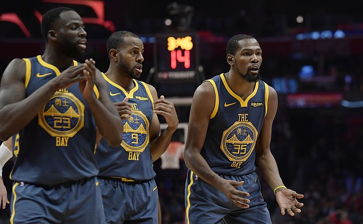 In this Nov. 12, 2018, file photo, Golden State Warriors forward Kevin Durant, right, reacts as he fouls out of the game while forward Draymond Green, left, and guard Andre Iguodala stand nearby during overtime of an NBA basketball game against the Los Angeles Clippers in Los Angeles. The Clippers won 121-116. Green's public outburst at Durant during the Warriors' loss on Nov. 12 lingers. Now there is tension on a team that has managed to remain mostly drama-free during its run. (Mark J. Terrill/AP, File)