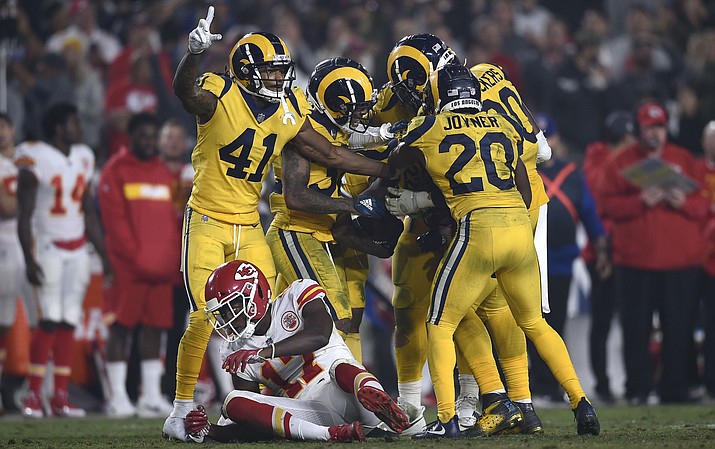 Los Angeles Rams players celebrate after cornerback Marcus Peters (obscured) intercepted a pass intended for Kansas City wide receiver Chris Conley, lower left, during the second half Monday, Nov. 19, 2018, in Los Angeles. (Kelvin Kuo/AP)