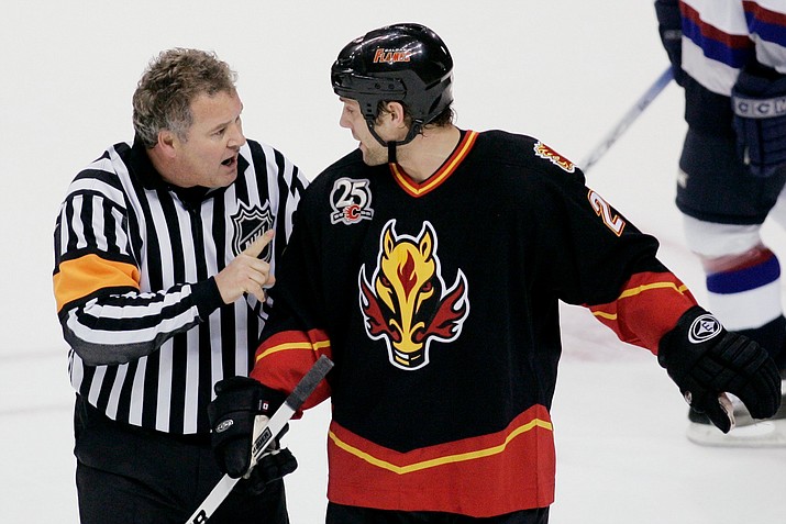 In this 2005 file photo referee Mick McGeough explains his penalty call on Calgary Flames’ Marcus Nilson during the first period of NHL hockey action against the Vancouver Canucks in Vancouver, British Columbia. (Richard Lam/AP)