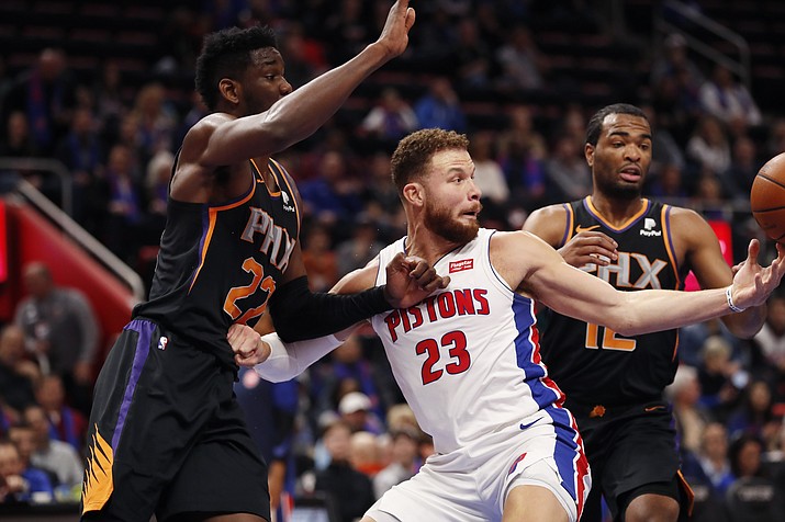 Phoenix Suns center Deandre Ayton (22), Detroit Pistons forwards Blake Griffin (23), T.J. Warren (12) and Detroit Pistons forward Blake Griffin (23) chase the rebound during the first half of an NBA basketball game, Sunday, Nov. 25, 2018, in Detroit. (Carlos Osorio/AP)