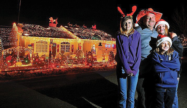 From Dec. 21, 2011, Kari, Dustin, Alyssa, and Kaitlyn McMillin gather together in front of their Prescott Valley home. The McMillins were the winners that year. (Courier, file photo)