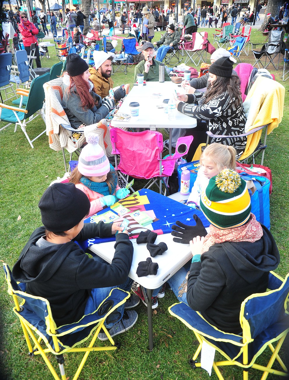 The Williams/Nesper families get some games of cards in before the 64th Annual Christmas Yavapai County Courthouse Lighting in downtown Prescott Satuday, Dec. 1, 2018. (Les Stukenberg/Courier)