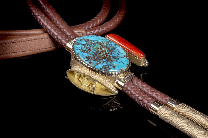 “Anasazi Village Bola Tie” by Alvin Yellowhorse, 18k gold, diamonds, Candelaria turquoise, Mediterranean Coral and leather, bola: 2-1/2” x 2-5/8” x 3/4”. At Turquoise Tortoise, a Bryant Nagel Gallery in Sedona.