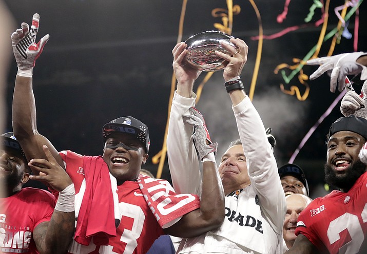 Ohio State head coach Urban Meyer and wide receiver Terry McLaurin, left, celebrate early Sunday, Dec. 2, 2018, after defeating Northwestern 45-24 in the Big Ten championship NCAA college football game in Indianapolis. (Michael Conroy/AP)