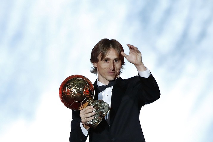Real Madrid's Luka Modric celebrates with the Ballon d'Or award during the Golden Ball award ceremony at the Grand Palais in Paris, France, Monday, Dec. 3, 2018. Awarded every year by France Football magazine since Stanley Matthews won it in 1956, the Ballon d'Or, Golden Ball for the best player of the year will be given to both a woman and a man. (Christophe Ena/AP)