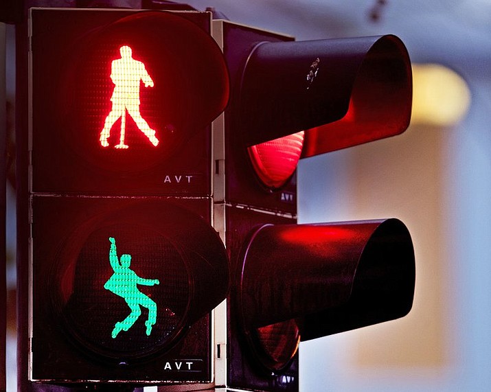 Walking figures depicting late US rock and roll legend Elvis Presley appear on a traffic light switching from green to red in Friedberg near Frankfurt, Germany, Thursday, Dec. 6, 2018. Presley served in Friedberg from October 1958 to March 1960 as a soldier in the US Armed Forces.( AP Photo/Michael Probst)