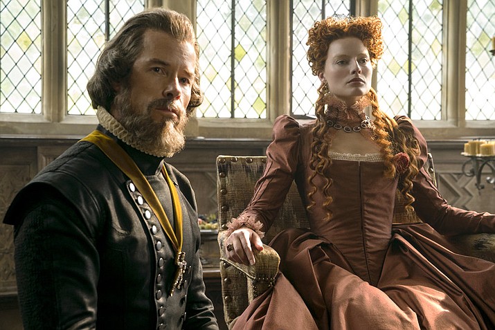 This image released by Focus Features shows Guy Pearce stars as William Cecil, left, and Margot Robbie as Queen Elizabeth in a scene from "Mary Queen of Scots." (Liam Daniel/Focus Features via AP)