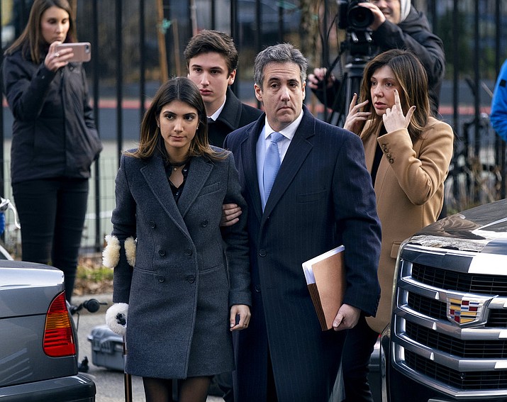 Michael Cohen, second from right, President Donald Trump's former lawyer, accompanied by his children from left, Samantha and Jake, and his wife Laura Shusterman, right, arrive at federal court for his sentencing for dodging taxes, lying to Congress and violating campaign finance laws in New York on Wednesday, Dec. 12, 2018. (AP Photo/Craig Ruttle)