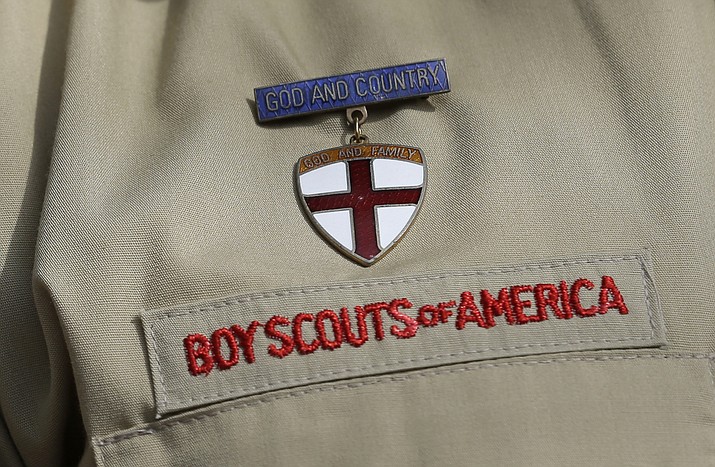 In this Feb. 4, 2013 file photo, shows a close up detail of a Boy Scout uniform worn during a news conference in front of the Boy Scouts of America headquarters in Irving, Texas. (AP Photo/Tony Gutierrez, File)