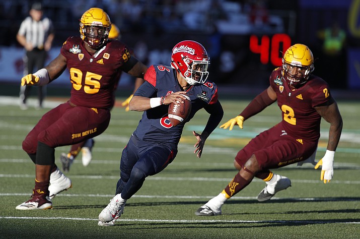 Fresno State quarterback Marcus McMaryion runs from Arizona State defensive players during the second half of the Las Vegas Bowl NCAA college football game, Saturday, Dec. 15, 2018, in Las Vegas. (John Locher/AP)
