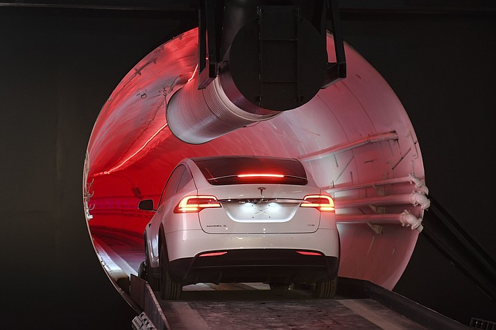 A modified Tesla Model X drives in the tunnel entrance before an unveiling event for the Boring Co. Hawthorne test tunnel in Hawthorne, Calif., Tuesday, Dec. 18, 2018. (Robyn Beck/Pool Photo via AP)