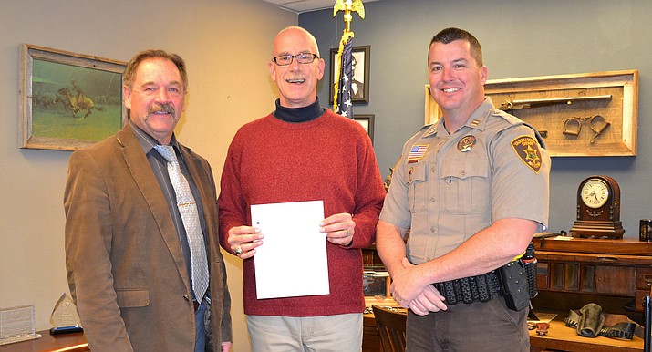 Yavapai County Sheriff Scott Mascher, U.S. Vets Development and Communications Manager in Prescott Matthew Phillips, and Yavapai County Sheriff’s Office Capt. Jeff Newnum, a veteran and current Detention Services Commander, pose for a photo after the Sheriff’s Office donated $3,615 to U.S. Vets following No Shave November. (Yavapai County Sheriff’s Office/Courtesy)
