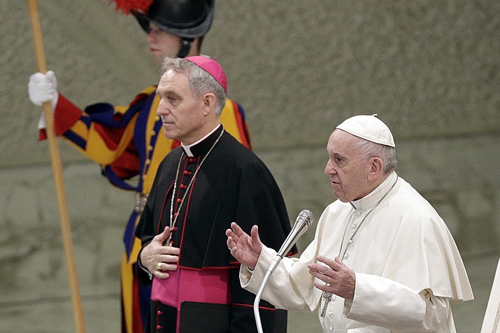 Pope Francis flanked by Monsignor Georg Gaenswein blesses the faithful on the occasion of the weekly general audience, at the Vatican, Wednesday, Dec. 19, 2018. (AP Photo/Gregorio Borgia)