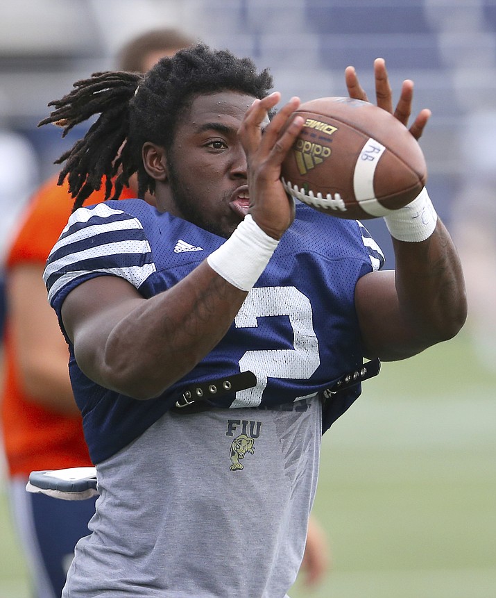 In this Thursday, Aug. 11, 2016, file photo, Florida International running back Anthony Jones catches a pass during an NCAA college football practice at Ocean Bank Field at FIU Stadium, in Miami. Jones and a teammate were hurt in a drive-by shooting on Sept. 6, 2018. Jones’ wounds have healed and he’s playing in the Bahamas Bowl on Friday, Dec. 21, as FIU takes on Toledo. (David Santiago/El Nuevo Herald via AP, File)