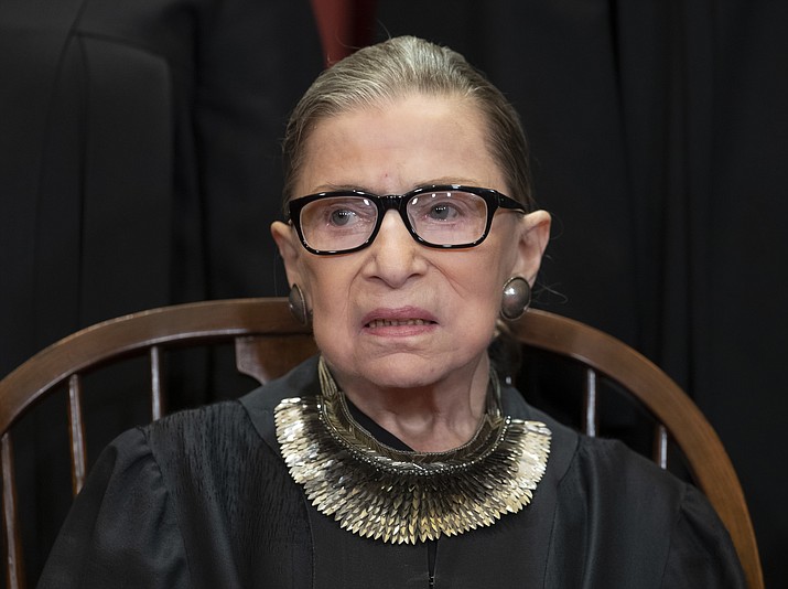 In this Nov. 30, 2018 file photo, Associate Justice Ruth Bader Ginsburg, nominated by President Bill Clinton, sits with fellow Supreme Court justices for a group portrait at the Supreme Court Building in Washington, Friday. The Supreme Court says Justice Ruth Bader Ginsburg has undergone surgery to remove two malignant growths from her left lung. It is Ginsburg’s third bout with cancer since joining the court in 1993. (AP Photo/J. Scott Applewhite)