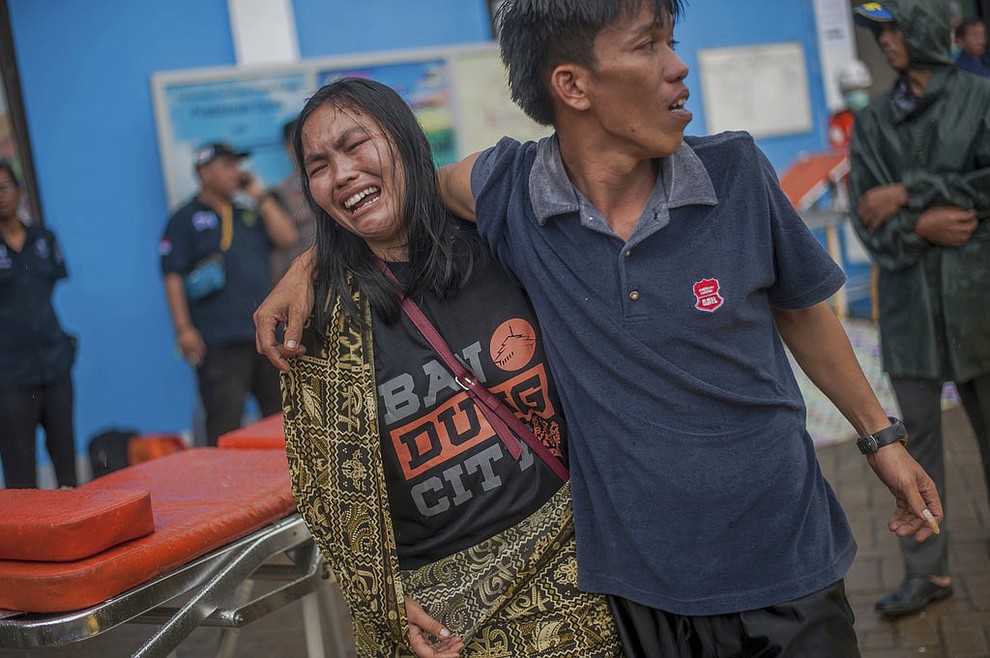 A woman reacts after identifying a relative among the bodies of tsunami victims in Carita, Indonesia, Sunday, Dec. 23, 2018. The tsunami occurred after the eruption of a volcano around Indonesia's Sunda Strait during a busy holiday weekend, sending water crashing ashore and sweeping away hotels, hundreds of houses and people attending a beach concert. (AP Photo/Fauzy Chaniago)