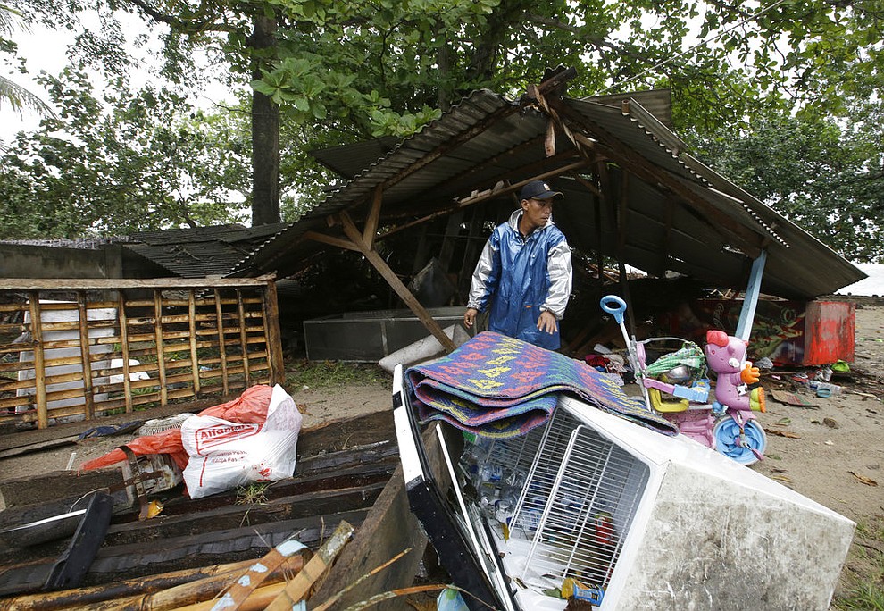 A men inspects his house damaged by a tsunami in Carita, Indonesia, Sunday, Dec. 23, 2018. The tsunami occurred after the eruption of a volcano around Indonesia's Sunda Strait during a busy holiday weekend, sending water crashing ashore and sweeping away hotels, hundreds of houses and people attending a beach concert. (AP Photo/Achmad Ibrahim)