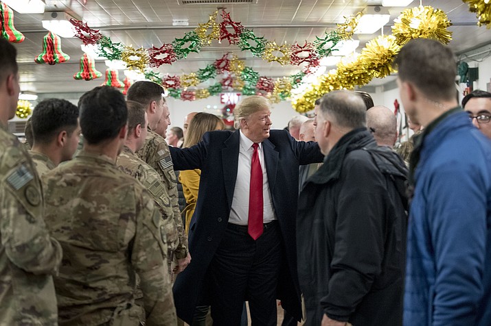 President Donald Trump visits with members of the military at a dining hall at Al Asad Air Base, Iraq, Wednesday, Dec. 26, 2018. (Andrew Harnik/AP)