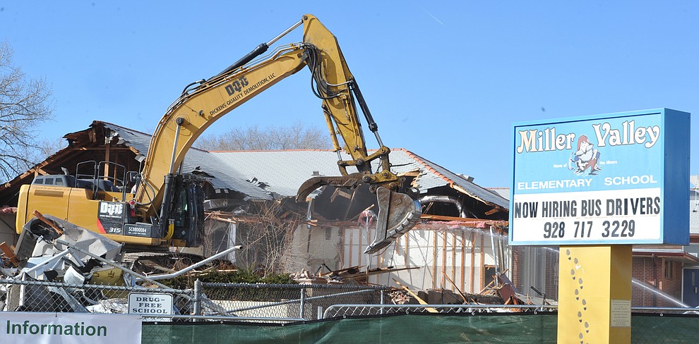 A crew from Dickens Quality Demolition tears down the 102-year-old Miller Valley Elementary School in Prescott Monday morning. (Les Stukenberg/Courier)