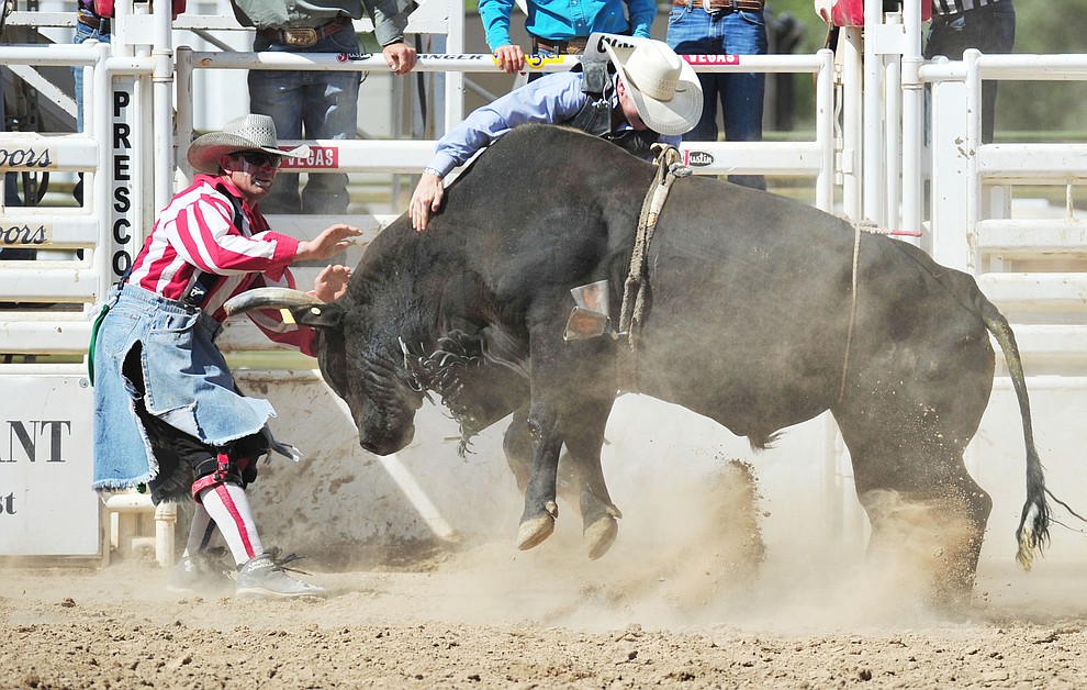 Bullfighter Quirt Hunt makes a save in the bull riding during the final performance of the 2018 Prescott Frontier Days Rodeo Wednesday, July 4, 2018. (Les Stukenberg/Courier)