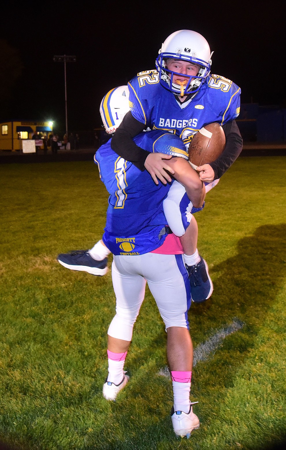 Ryan Tardibuono celebrates with Nathan Briseno (1) after scoring a touchdown before the Prescott Badgers play cross mountain rival Mingus for the region title Friday, Oct. 26, 2018 in Prescott. (Les Stukenberg/Courier).