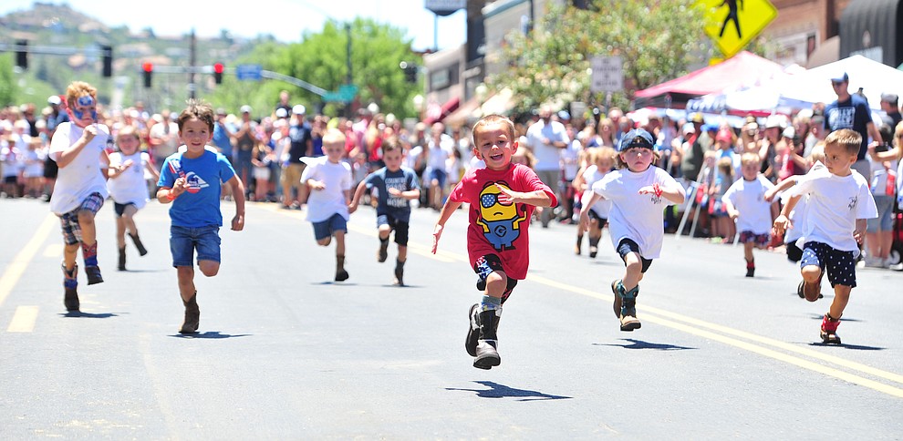 Mikey Kleiner has the lead in the second heat of the four to five year old races during 36th annual Whiskey Row Boot Race along Montezuma Street in downtown Prescott Saturday, June 30, 2018.(Les Stukenberg/Courier)