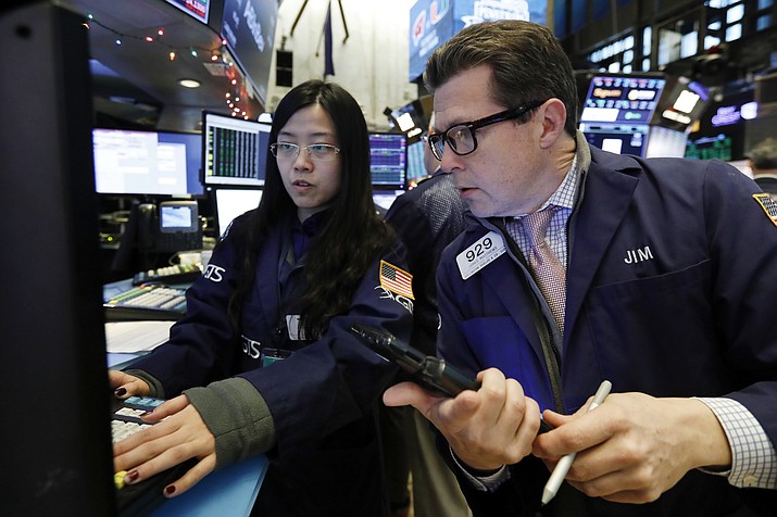 Specialist Vera Liu, left, and trader James Matthews work on the floor of the New York Stock Exchange, Wednesday, Dec. 26, 2018. Stocks are opening higher on Wall Street Wednesday, with real estate, raw materials and energy stocks leading a broad rebound from Monday's steep losses. (Richard Drew/AP)