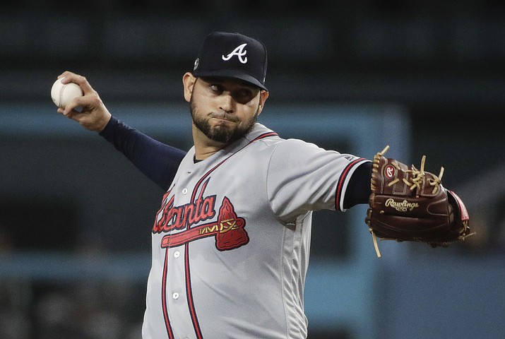 This Oct. 5, 2018, file photo shows Atlanta Braves starting pitcher Anibal Sanchez throwing to a Los Angeles Dodgers batter during the first inning of Game 2 of a baseball National League Division Series in Los Angeles. The Washington Nationals have agreed to terms on a two-year contract with Sanchez. The deal, announced Thursday, Dec. 27, 2018, by the Nationals, includes a team option for 2021. (Jae C. Hong/AP, file)