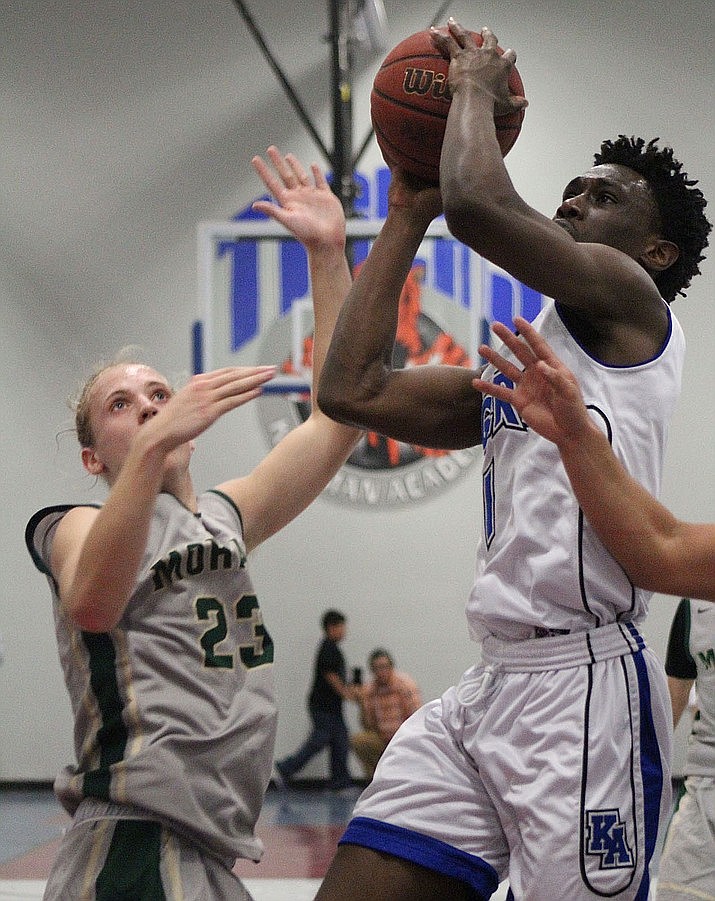November 20 – Kingman Academy's Tyler Chinyere drives to the basket for two of his game-high 27 points Monday night against Mohave.