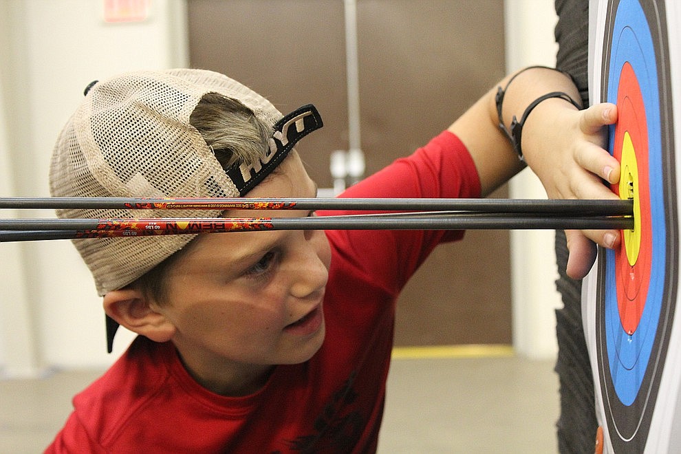 June 20 – Hayden Gonzales, 11, counts the points on his target at Inside Out Archery. Corbin and Brad Rowden host weekly shooting sessions at the Mohave County Fairgrounds.