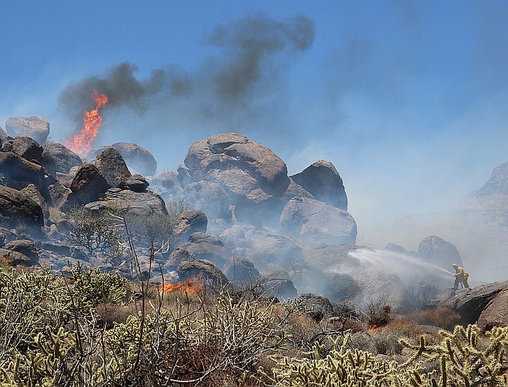 June 4 – A brush fire broke out in the foothills at the end of Jagerson Avenue in Northwest Kingman Monday afternoon. More than 16 firefighters helped extinguish the fire, and one firefighter from Pinion Pines was treated and released with heat exhaustion. (Photo by Travis Rains/Daily Miner)