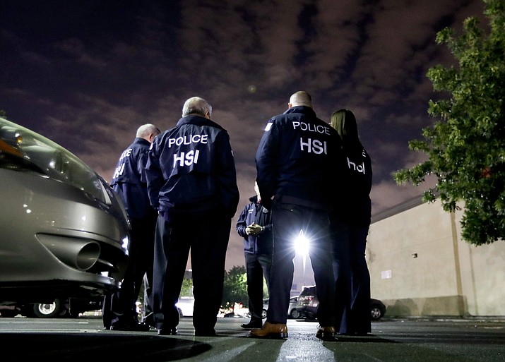 U.S. Immigration and Customs Enforcement agents gather before serving an employment audit notice at a 7-Eleven convenience store, in Los Angeles. U.S. Immigration and Customs Enforcement is the face of President Donald Trump’s hard-line immigration policy. But agency officials say their mandate is misunderstood. (Chris Carlson/AP, File)