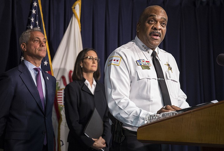 Chicago Police Superintendent Eddie Johnson, accompanied by Illinois Attorney General Lisa Madigan, center, and Chicago Mayor Rahm Emanuel, speaks at a news conference Aug. 29, 2018, in Chicago. Preliminary numbers show homicides in Chicago fell by about 100 over the last year compared to 2017 according to a police report on Tuesday, Jan. 1, 2019. (Rich Hein/Chicago Sun-Times via AP, File)