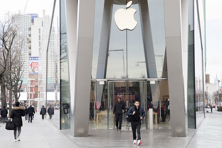 Customers leave the Apple store in the Brooklyn borough of New York, Thursday, Jan. 3, 2019. Apple's shock warning that its Chinese sales are weakening ratcheted up concerns about the world's second largest economy and weighed heavily on global stock markets as well as the dollar on Thursday. (Mary Altaffer/AP)