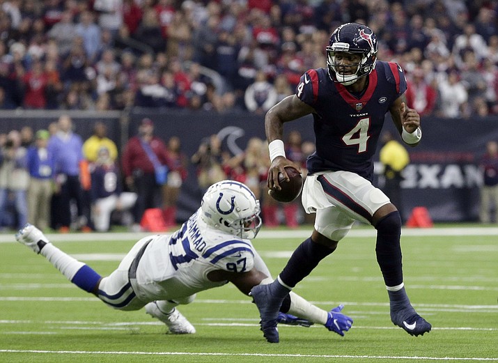 Houston Texans quarterback Deshaun Watson (4) breaks away from Indianapolis Colts defensive tackle Al-Quadin Muhammad (97) during the second half of an NFL football game Sunday, Dec. 9, 2018, in Houston. (Michael Wyke/AP)