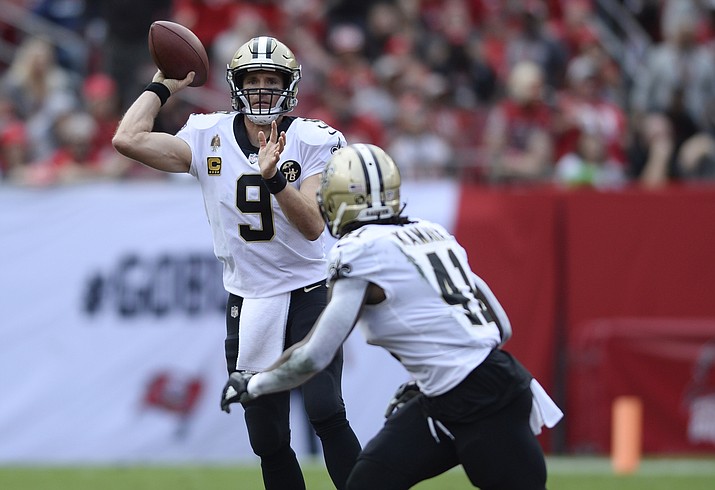 In this Dec. 9, 2018, file photo, New Orleans Saints quarterback Drew Brees (9) throws a pass to running back Alvin Kamara (41) during the first half of the team's NFL football game against the Tampa Bay Buccaneers in Tampa, Fla. Brees, who turns 40 on Jan. 15, is a leading MVP candidate after breaking his own NFL record for completion percentage, connecting on 74.4 percent of his passes a year after connecting on 72 percent. (Jason Behnken/AP, file)
