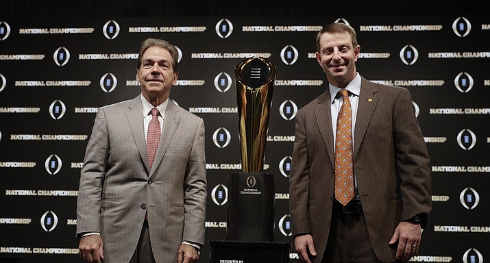 Alabama head coach Nick Saban and Clemson head coach Dabo Swinney pose with the trophy at a news conference for the NCAA college football playoff championship game Sunday, Jan. 6, 2019, in Santa Clara, Calif. (David J. Phillip/AP)